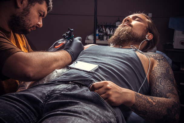 Tattooer pózol tetováló szalon - Fotó, kép