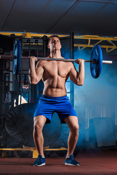 man doing exercises with barbell - Photo, Image