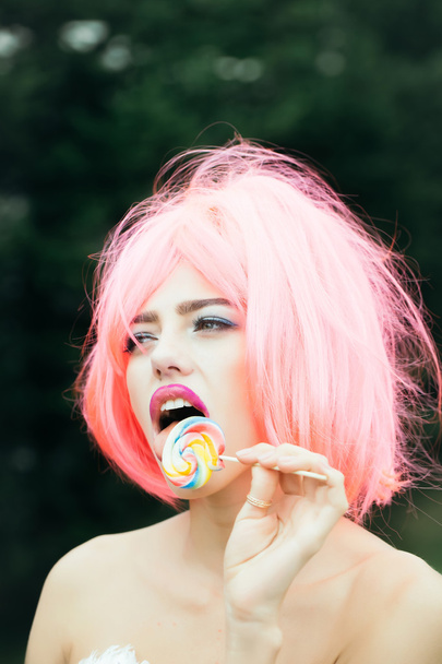 woman with orange hair lick lollipop - Fotoğraf, Görsel