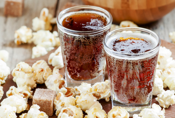 Caramel popcorn and cola in a glasses - Фото, изображение