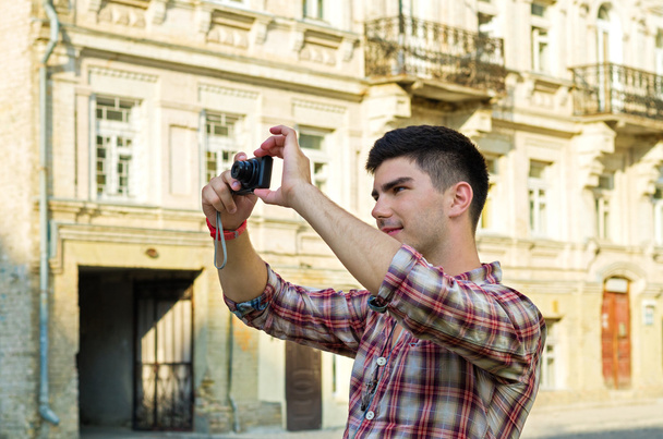 Young man taking photographs - Photo, Image