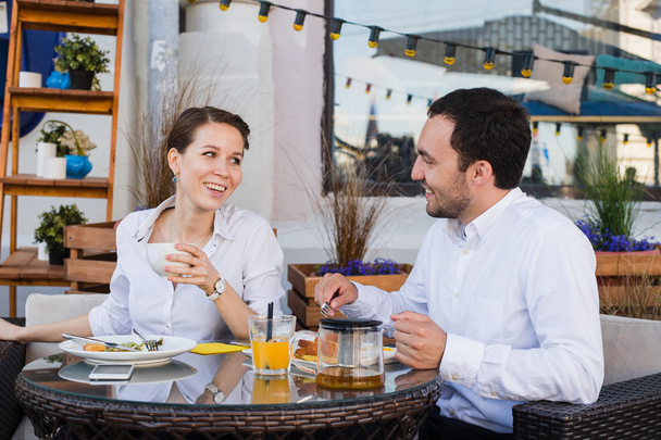Счастливые деловые люди за обедом в кафе
 - Фото, изображение