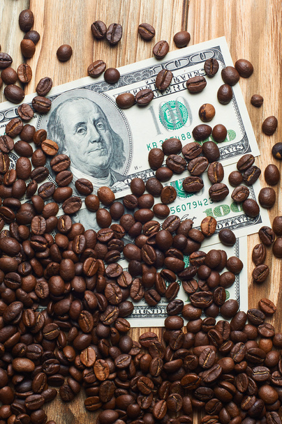 Coffee and money on a wooden table. Earnings on coffee. - Photo, Image
