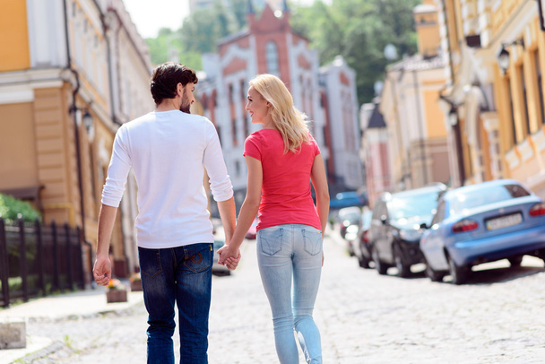 Cheerful loving couple walking in city - Photo, image