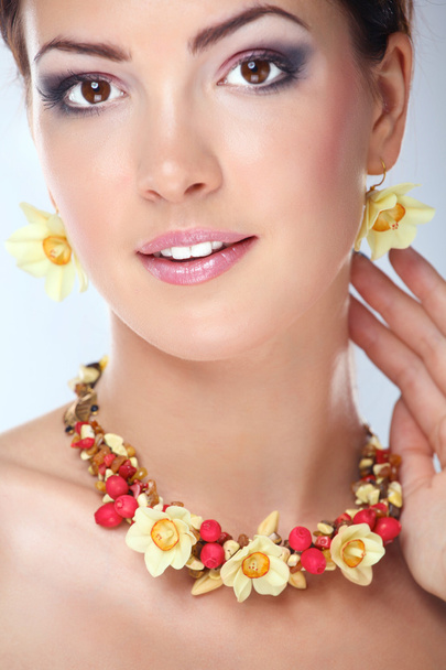 Portrait of young beautiful brunette woman in beads - Фото, зображення