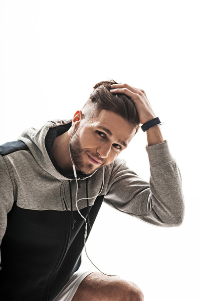 Handsome sportsman enjoying melody from earphones - Photo, Image
