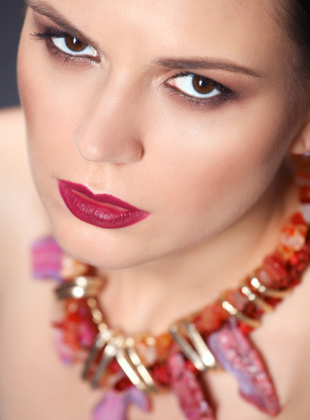 Portrait of young beautiful brunette woman in beads - Fotoğraf, Görsel
