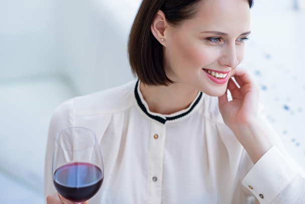 Happy businesswoman enjoying red wine - Zdjęcie, obraz