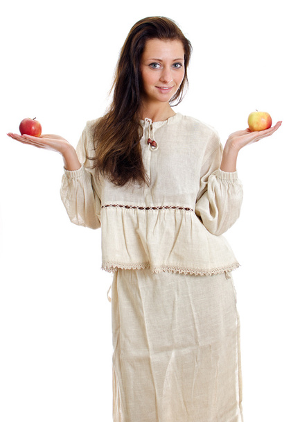 Female in national traditional costume with two apples. Isolated on white. - Photo, image
