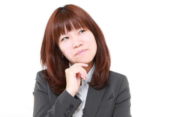 young Japanese businesswoman thinks about something - Valokuva, kuva