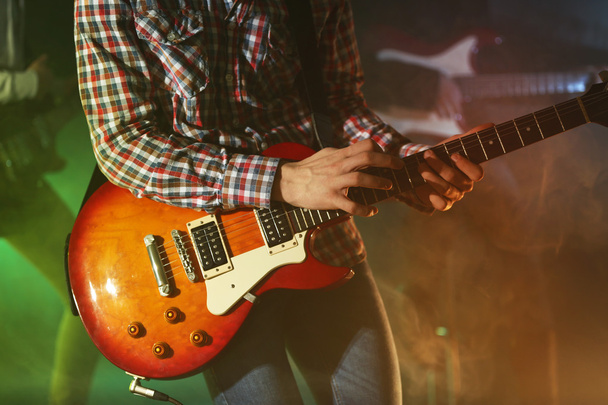 Young man playing electric guitar  - Fotó, kép