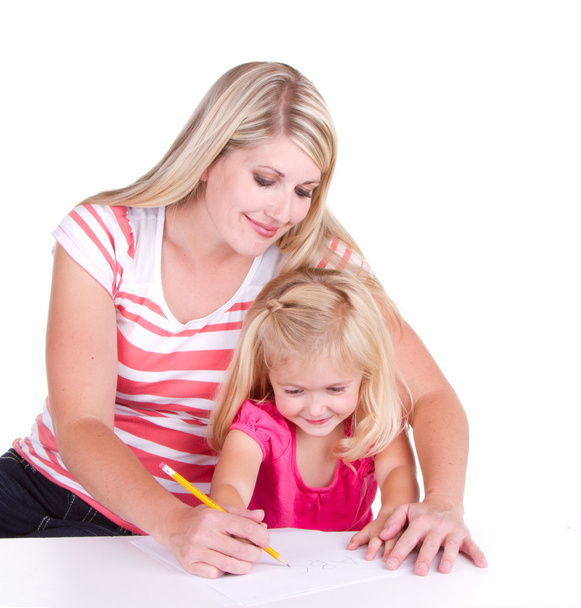 Mother helping daughter write alphabet - Foto, immagini