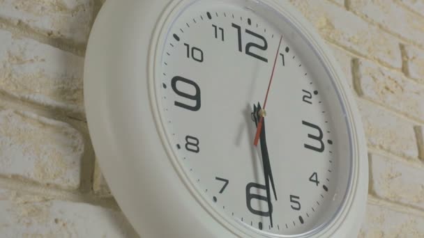 Time five hours thirty minutes. Timelapse. Round white clock hanging on brick wall. - Footage, Video