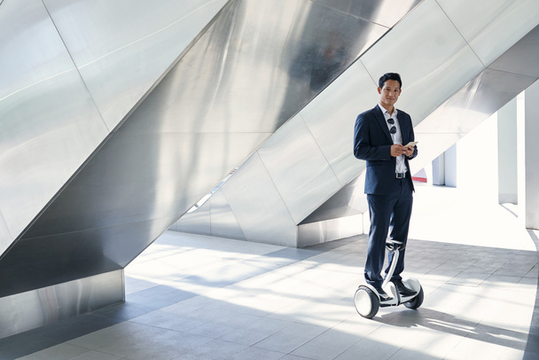 businessman standing on hoverboard - Photo, Image