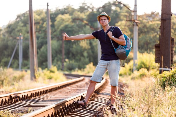 Backpacker catching Train on Countryside Railroad - 写真・画像