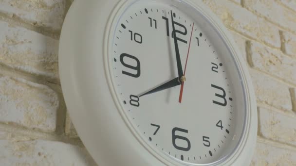 Time eight hours. Timelapse. Round white clock hanging on brick wall. - Footage, Video