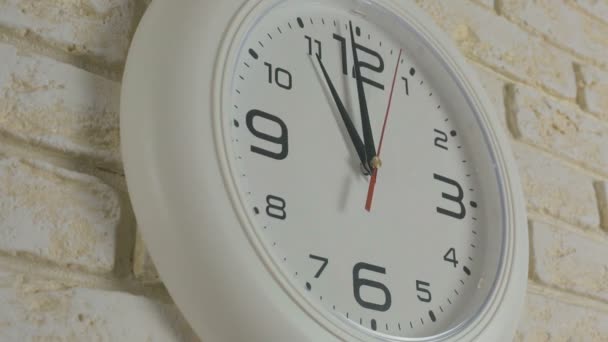 Time eleven hours. Timelapse. Round white clock hanging on brick wall. - Footage, Video