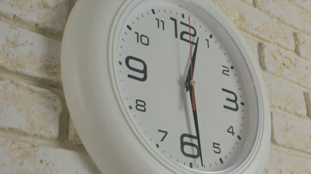 Time twelve hours thirty minutes. Timelapse. Round white clock hanging on brick wall. - Footage, Video