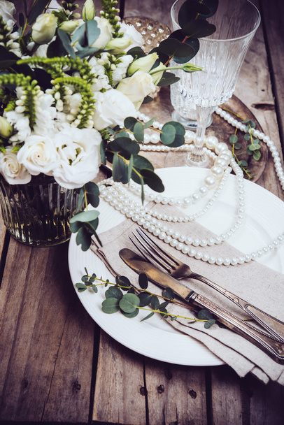 Vintage wedding table decor, tableware, flowers and pearl beads - Photo, image