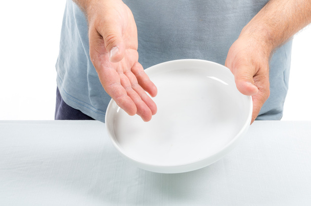 Man Holding an Empty Dish in his Hands indicating no conten - Φωτογραφία, εικόνα