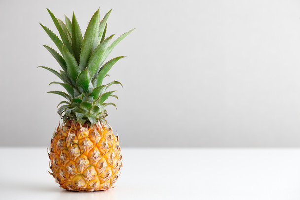 Ripe pineapple on a white table - Foto, Imagem