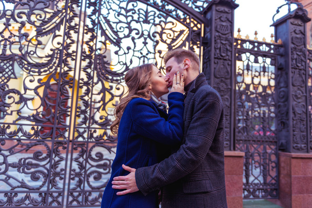 Couple kissing near the gate - Photo, Image