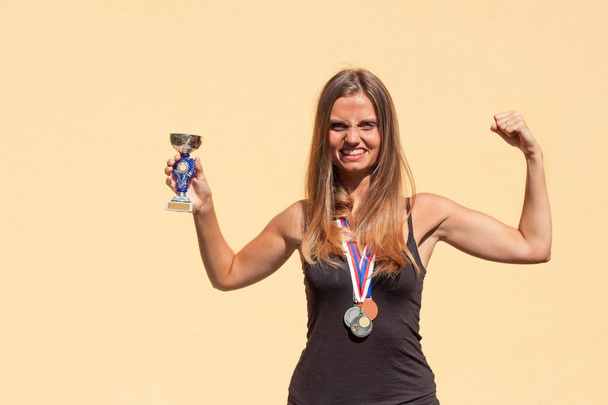 Beautiful girl and sports medals. Sports champion. Awards for sporting achievements. - Fotoğraf, Görsel