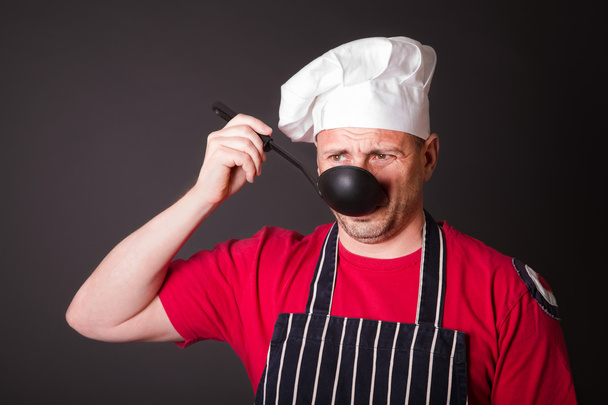 Portrait of the funny cook with a ladle in his hand - Photo, Image