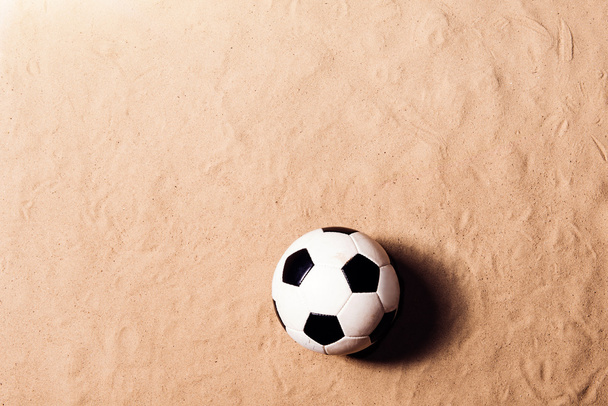 Soccer ball against sandy beach. Studio shot. Copy space. - Фото, зображення