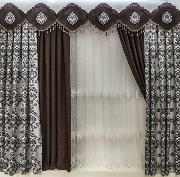 The stylish design of the window opening. Combined brown curtains, a pelmet and a tulle. - Photo, Image