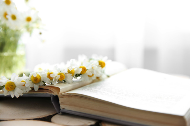 Chamomile bouquet on book - 写真・画像