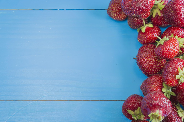 Fresh strawberries on blue background - Fotografie, Obrázek
