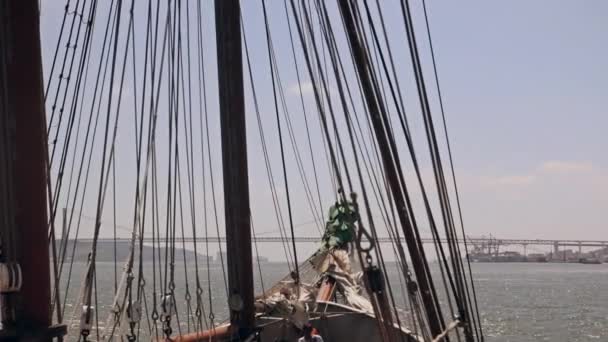 Ship sails through the waves on a bridge background Lisbon - Footage, Video