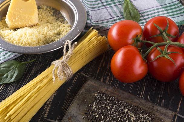 Pasta, tomatoes and grated cheese. - Photo, Image