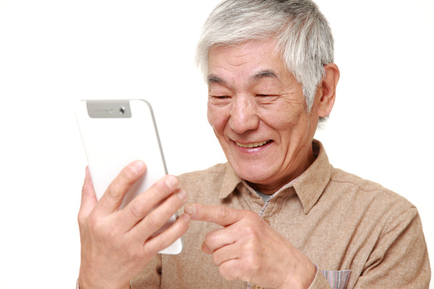 senior Japanese man using tablet computer - Foto, imagen