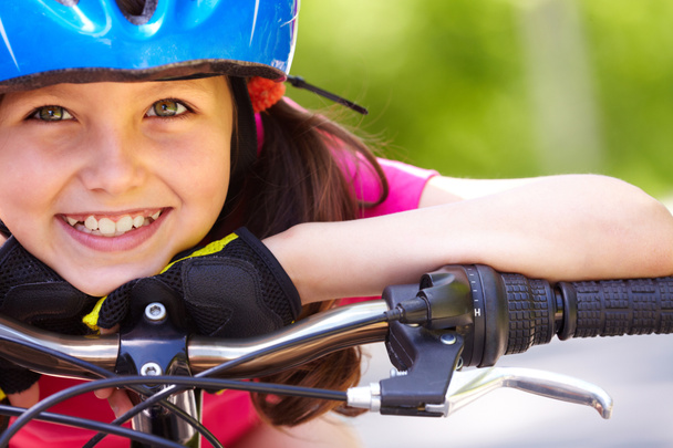 Little girl's face on bike - Photo, Image