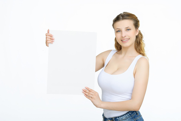 Young smiling woman show blank card or paper on white background. - Photo, Image