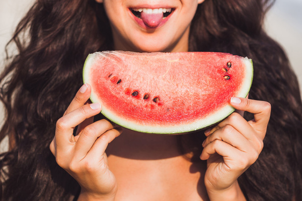 Girl eating watermelon with happy smile - Foto, imagen