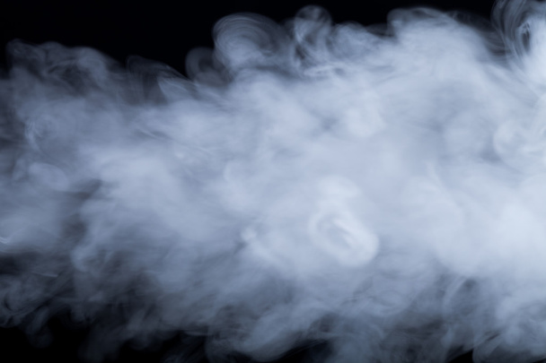 Cloud of smoke on black background. Selective focus - Photo, Image