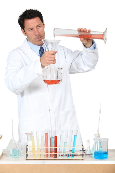 Man in white laboratory coat with test tubes - 写真・画像