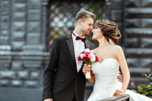 Braut und Bräutigam mit Blumenstrauß - Foto, Bild