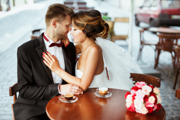 Bride and bridegroom sitting in cafe - Photo, Image