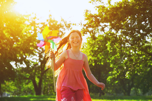 Happy girl with pinwheel toy - Zdjęcie, obraz