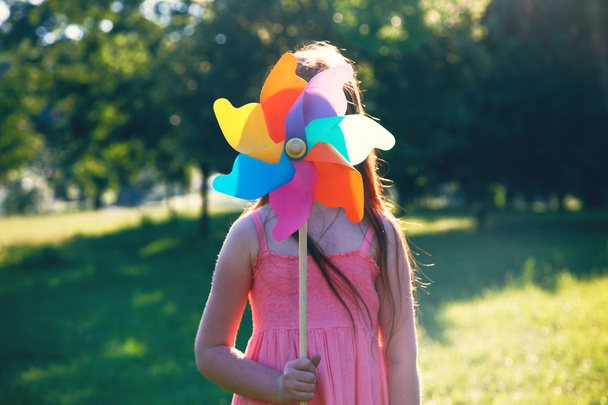 Happy girl with pinwheel toy - Photo, image