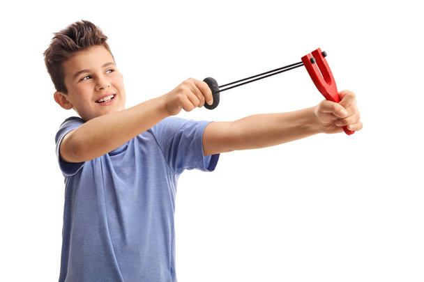 Cheerful kid shooting with a slingshot - 写真・画像
