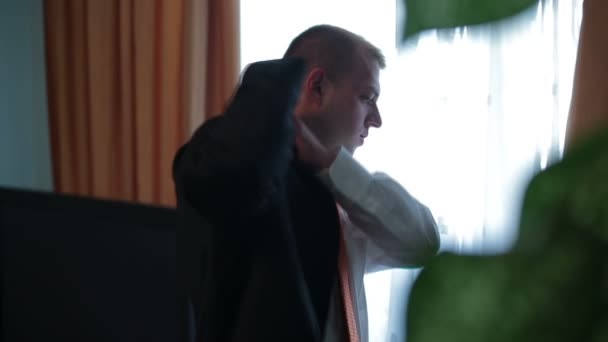 Groom wears a jacket close up - Filmati, video