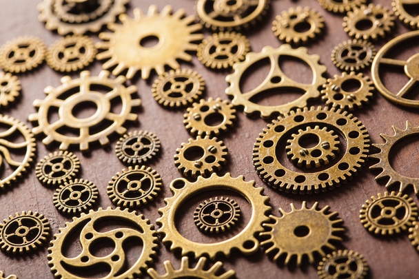 steampunk mechanical cogs gears wheels on wooden background - Foto, imagen
