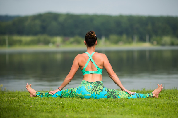 Yoga girl formación al aire libre sobre fondo de la naturaleza. Concepto de yoga
. - Foto, Imagen