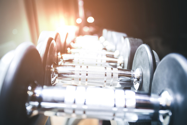 blurred  Image Rows of dumbbells in the gym - Photo, Image