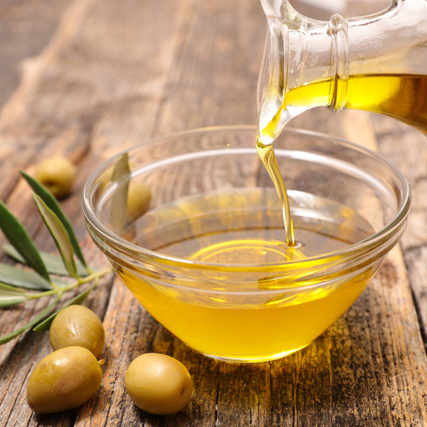 olive oil with green olives - Fotó, kép